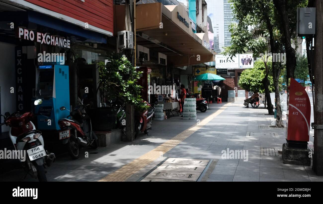 Man in Wheel Chair Begging in the Emptiness on Sukhumvit Road or Highway 3 Soi Nana Area Bangkok Thailand Stock Photo