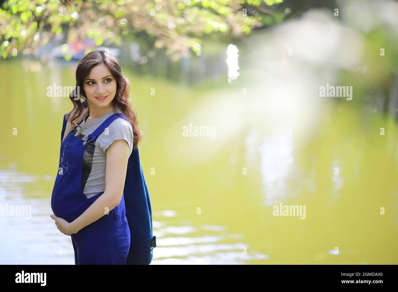 Pregnant woman on a walk in the park Stock Photo - Alamy
