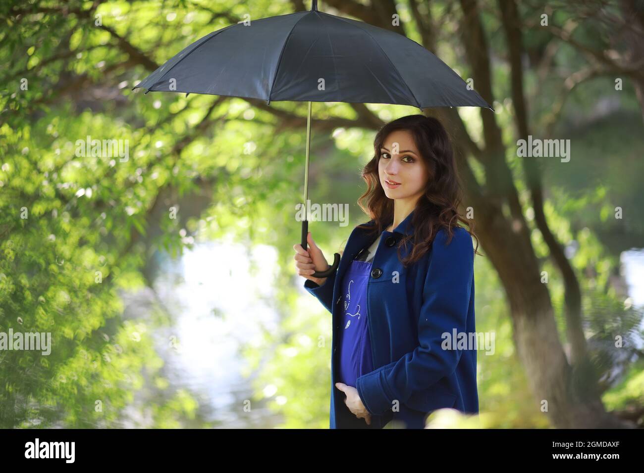 Pregnant woman on a walk in the park Stock Photo - Alamy