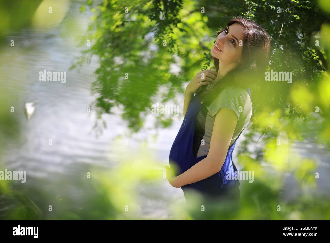 Pregnant woman on a walk in the park Stock Photo - Alamy