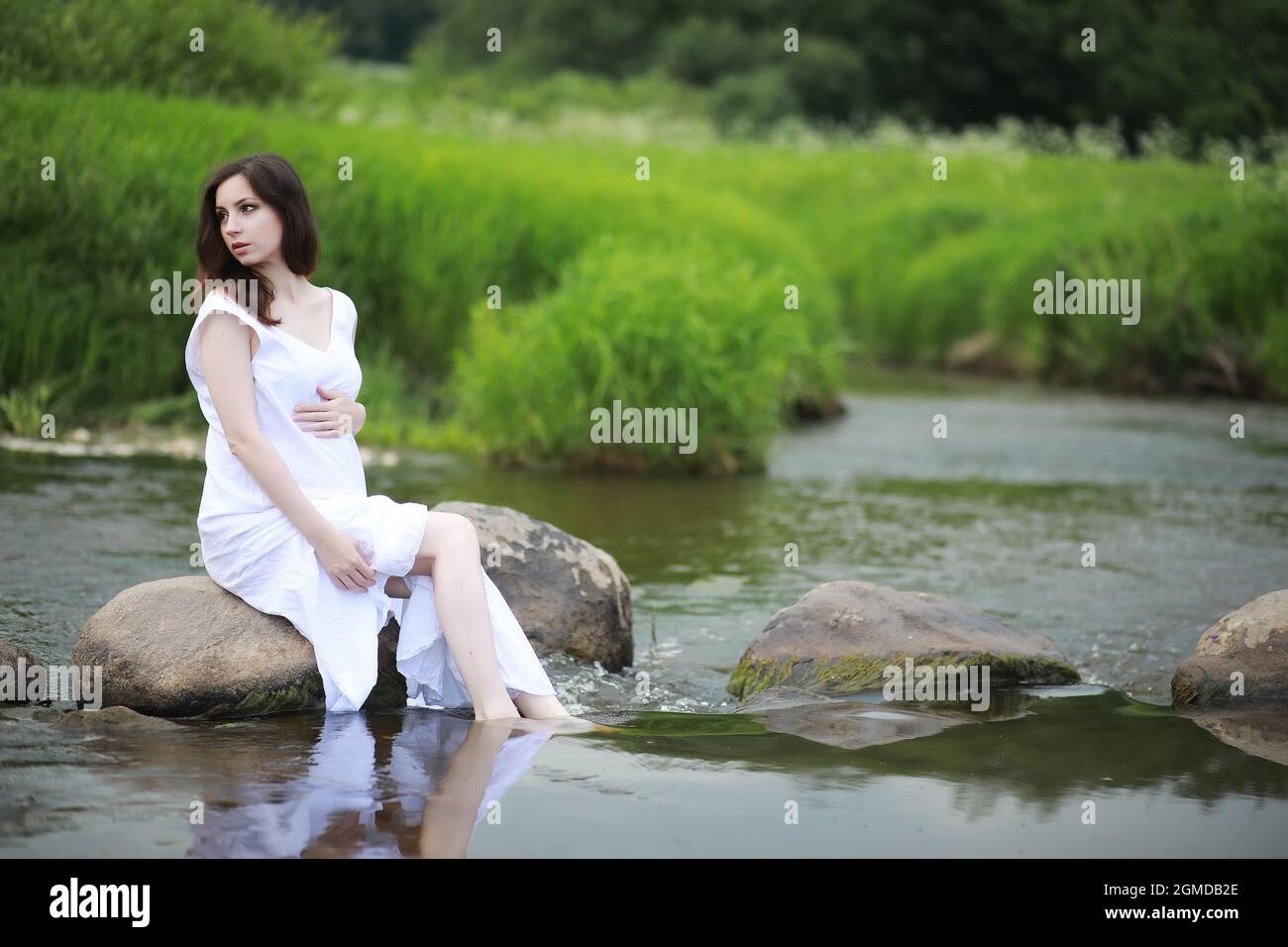 Pregnant woman in nature for a walk in the summer Stock Photo - Alamy