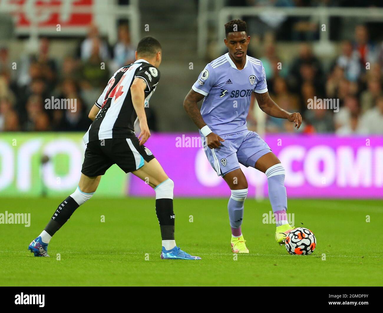 NEWCASTLE UPON TYNE, ENGLAND - SEPTEMBER 17: Junior Firpo of Leeds United  and Miguel Almiron of Newcastle United during the Premier League match between Newcastle United and Leeds United at St. James Park on September 17, 2021 in Newcastle upon Tyne, England. (Photo by MB Media) Stock Photo
