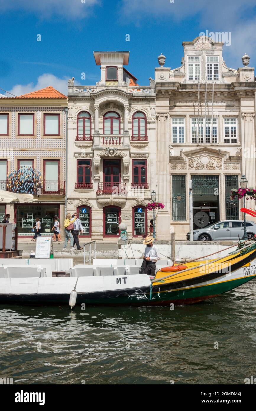 Aveiro, Portugal, Canals with Moliceiros, traditional gondola boat with art nouveau buildings behind, Aveiro canals, Europe Stock Photo