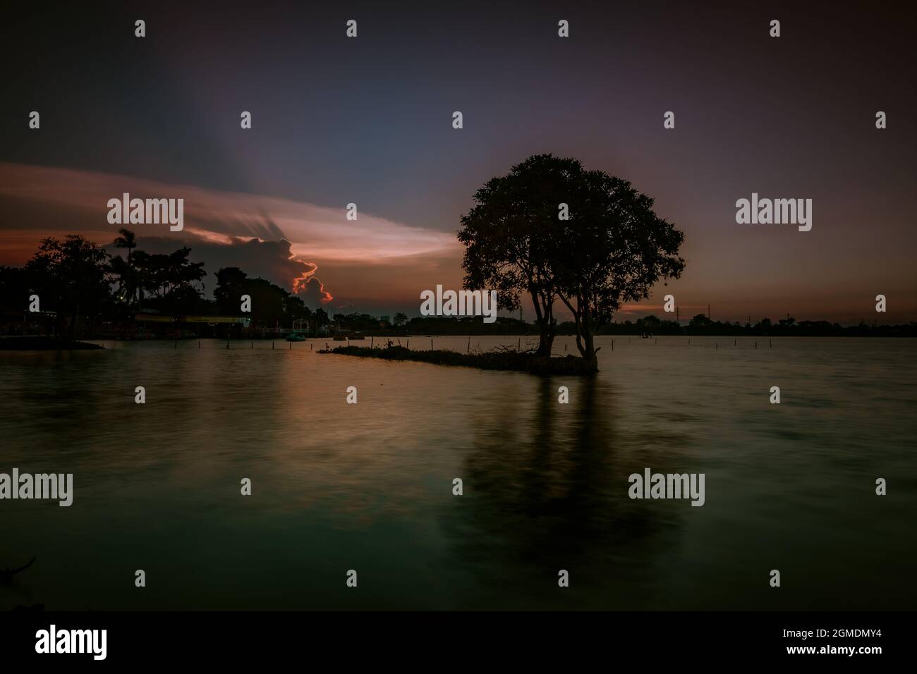 Lake view in the evening with blue sky and calm lake water covered with ...