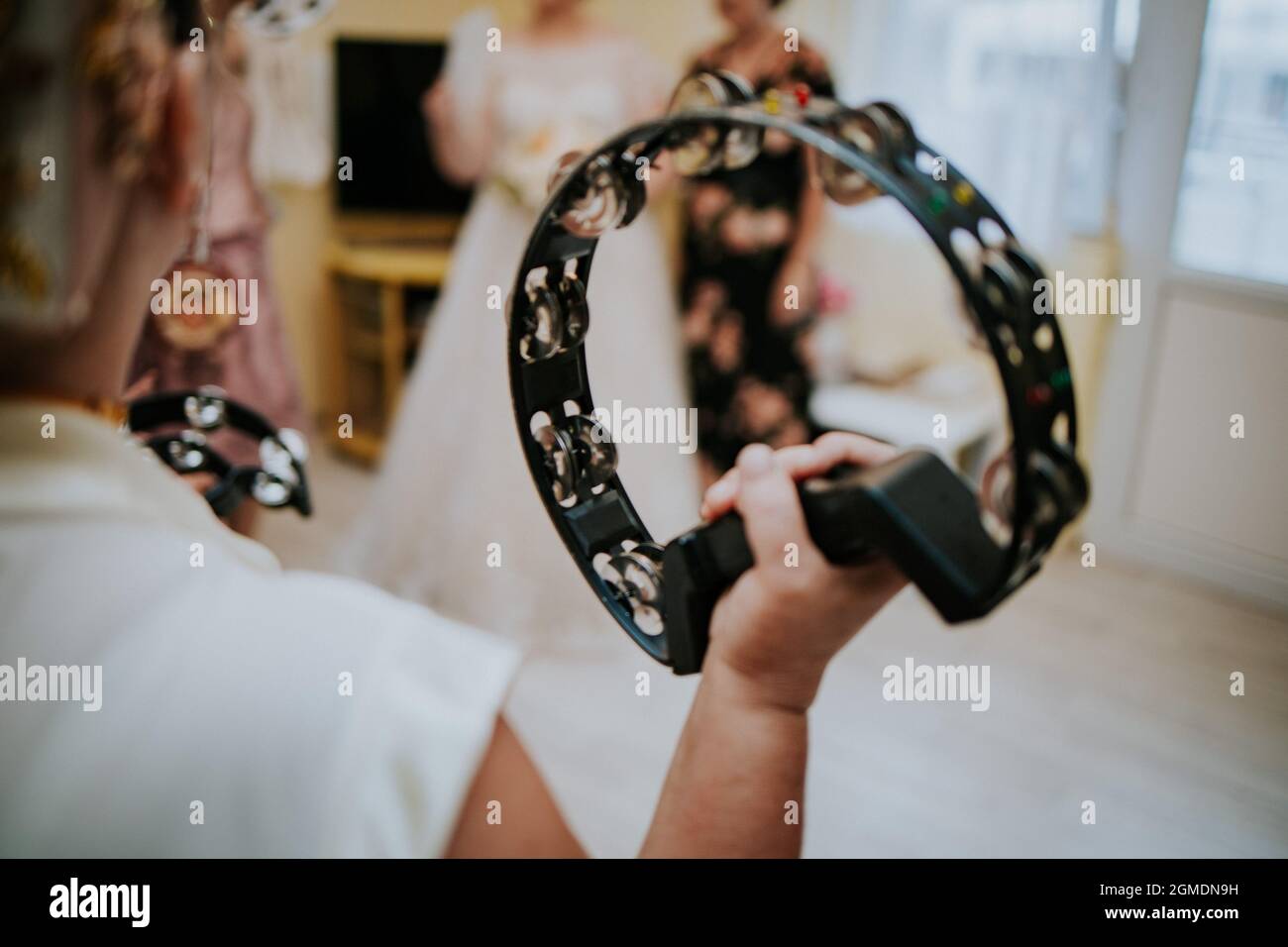 Group of female musicians playing tambourine at a wedding ceremony
