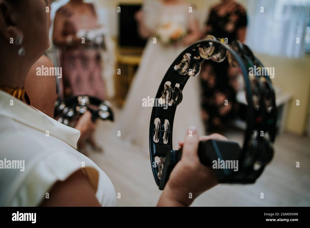 Group of female musicians playing tambourine at a wedding ceremony