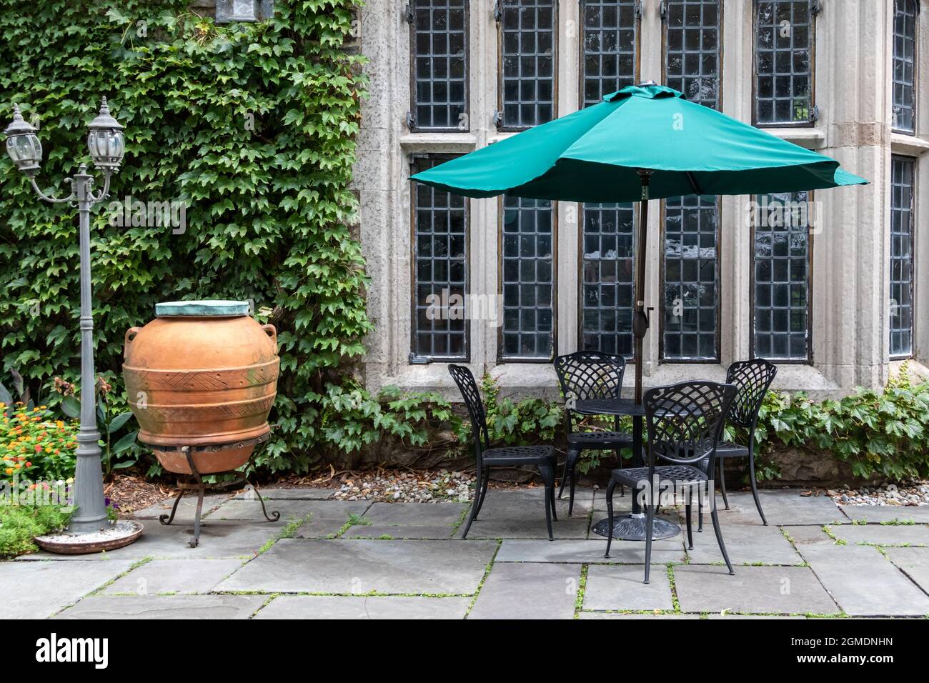 Wrought iron patio set and turquiose umbrella create a lovely setting