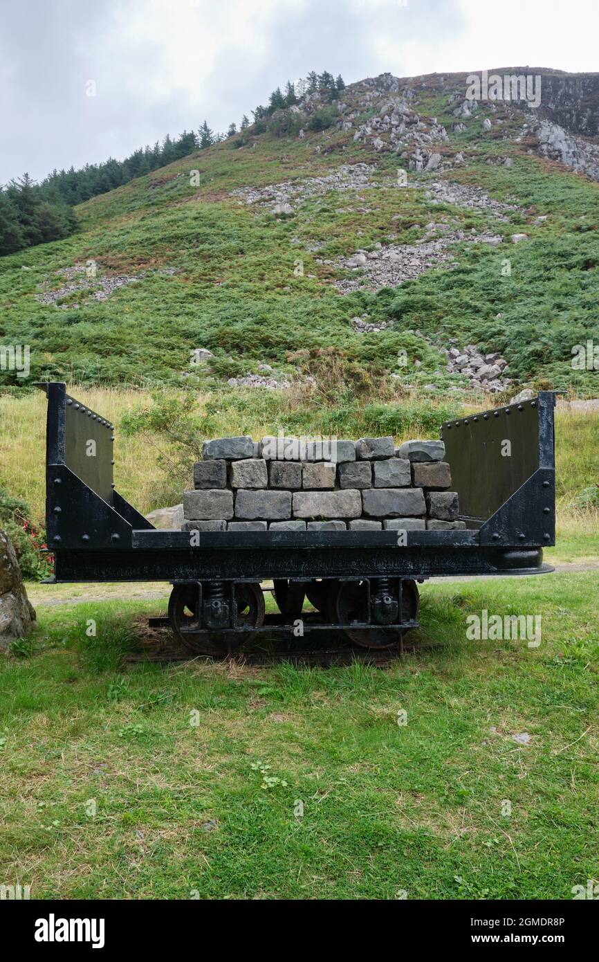 Display of granite setts on a rail wagon used to transport the stone down to the port at Nant Gwrtheyrn when it was a working quarry. Stock Photo
