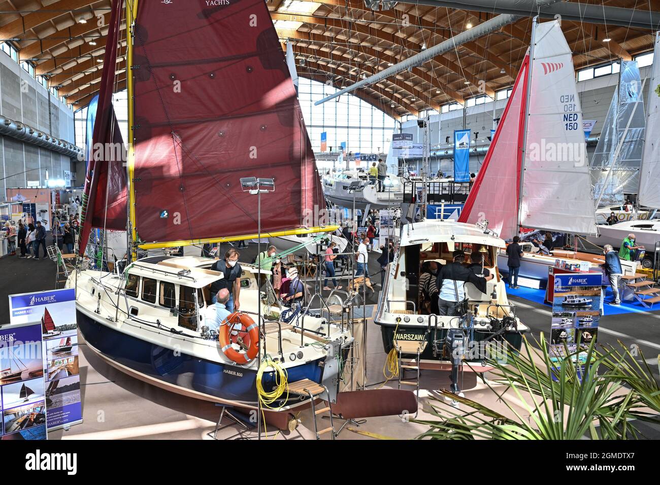 Berlin, Germany. 26th Sep, 2019. Visitors take a look at what's new in the boating industry in exhibition hall A3, here at the Haber stand. The Haber 800 (l) can be seen in the foreground. For the 60th time, water sports enthusiasts and fans of sailing and motor boats as well as fun sports will meet to find out about trends and new products from more than 260 exhibitors. Credit: Felix Kästle/dpa/Alamy Live News Stock Photo