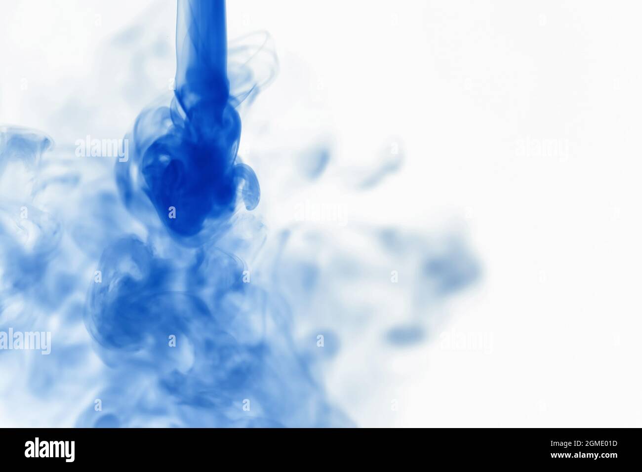 Puffs of paint in water. The dissolution of dye in water. Water