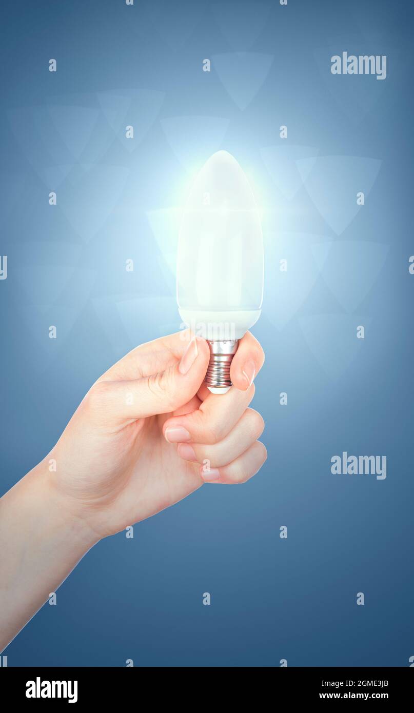 Good ideas with innovation and creativity concept. Young women hand holding lightning bulb Stock Photo
