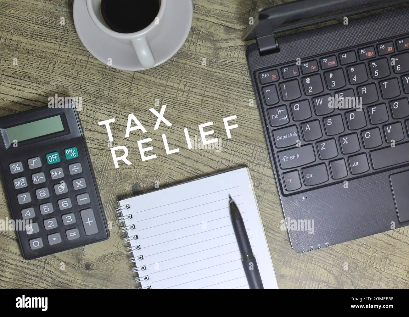 Top view of TAX RELIEF text, coffee, pen, notebook, laptop and calculator  Stock Photo - Alamy