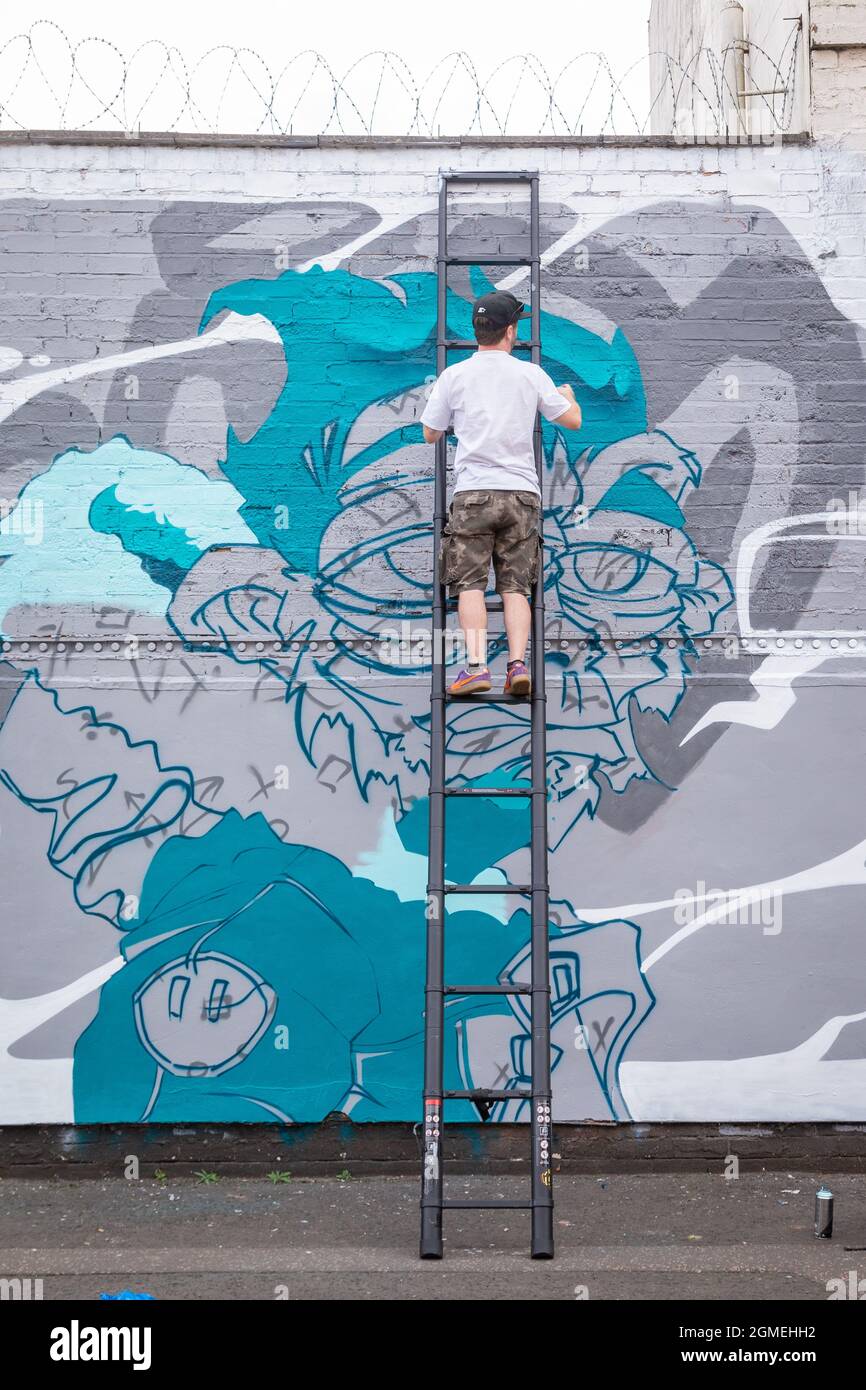 Birmingham, UK. 18th Sep, 2021. A graffiti artist at work during the High Vis Street Culture Festival taking place over the weekend in Digbeth, Birmingham. The Digbeth district of the city is reknowned for its street graffiti culture. Credit: Peter Lopeman/Alamy Live News Stock Photo