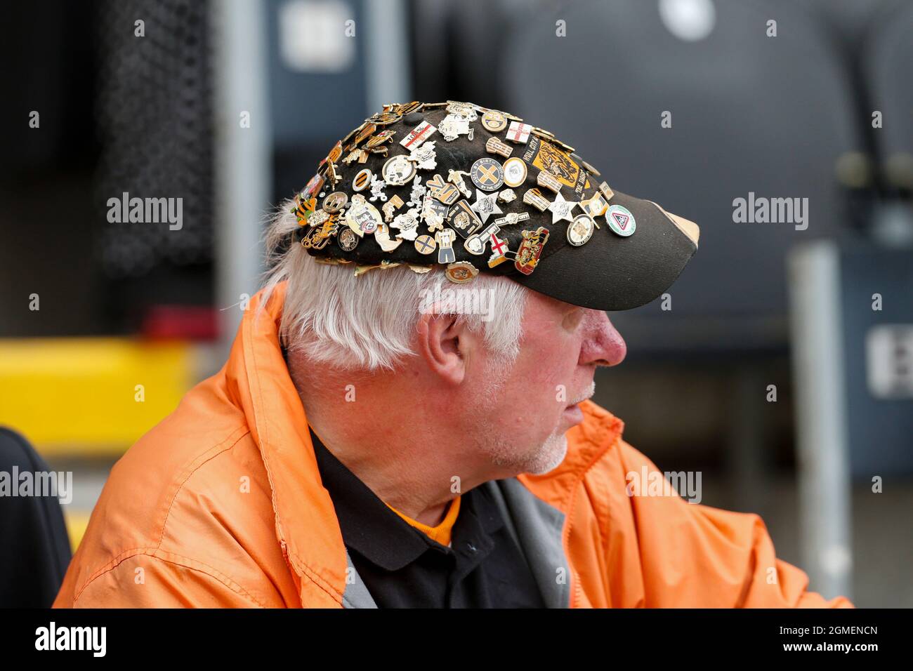 A fan of Hull City wears a hat covered in pin badges Stock Photo Alamy