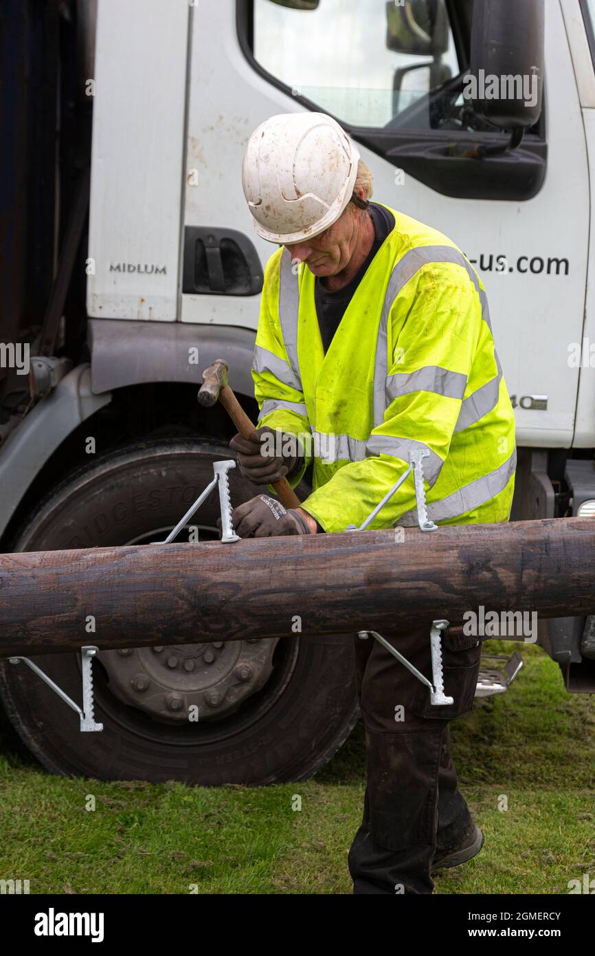 installing a pole for an overhead fiber Optic Broadband Cable Stock Photo