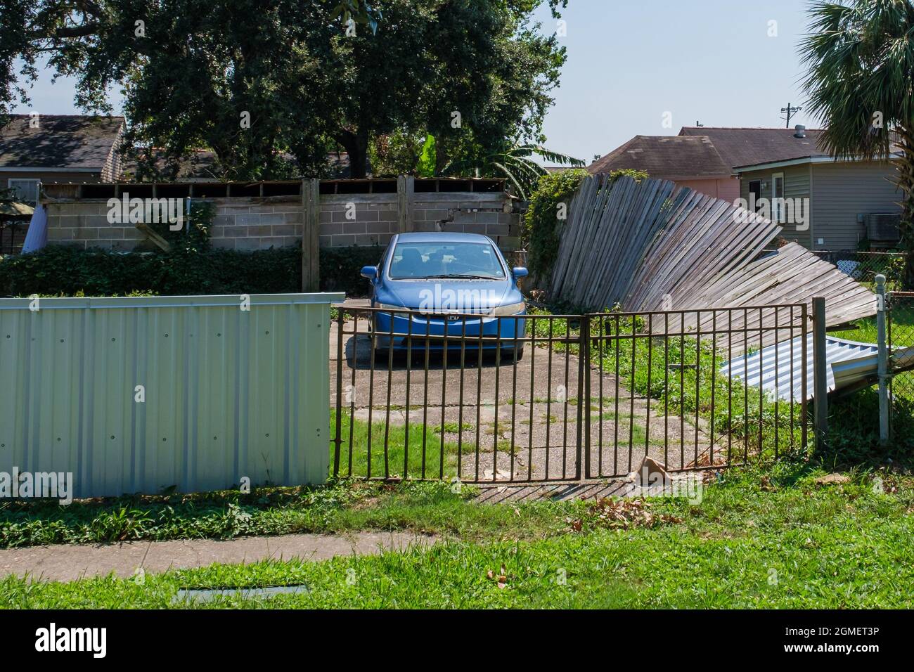 NEW ORLEANS, LA, USA - SEPTEMBER 9, 2021: Fence blown down by Hurricane Ida in Gentilly Neighborhood Stock Photo