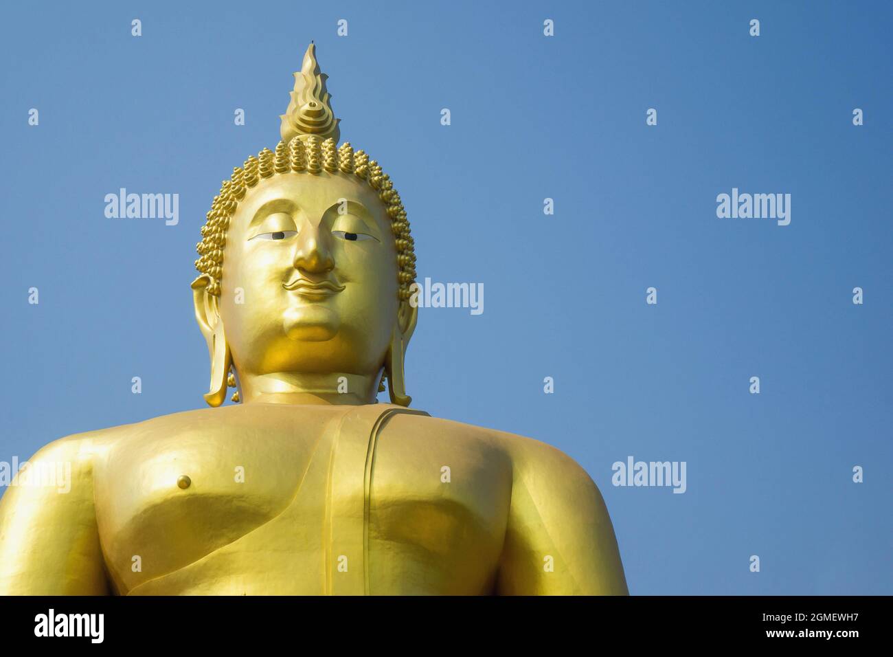 Statue of giant gold Buddha in blue sky background Stock Photo - Alamy