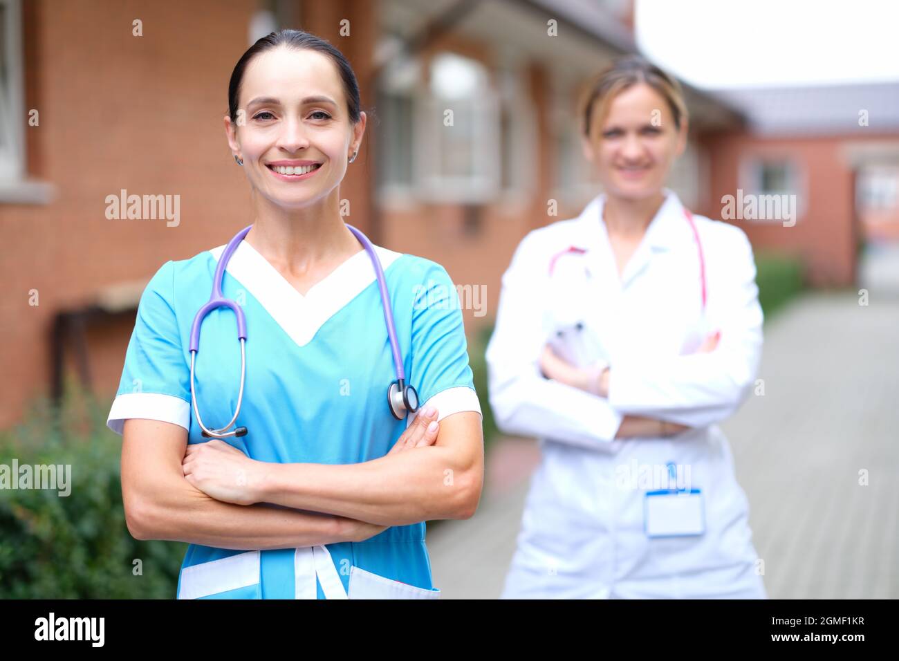 Attractive nurse standing near hi-res stock photography and images - Alamy