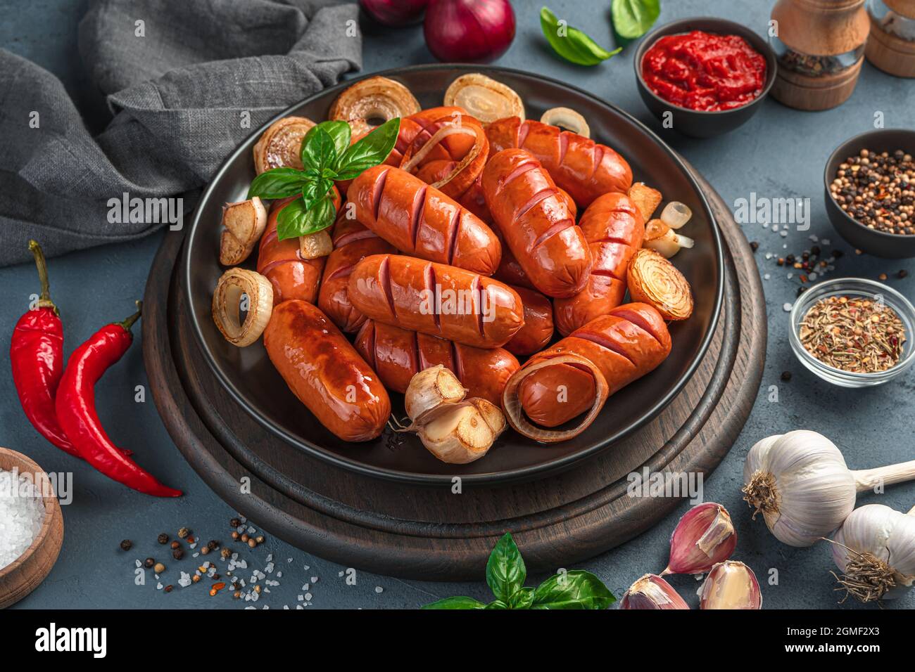 Delicious, fried sausages with onions and garlic close-up. Fast food, beer appetizer. Stock Photo