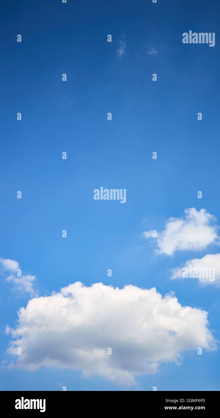 Cloud single lonely in high empty sky with beams vertical composition 16x9 with copyspace. Stock Photo