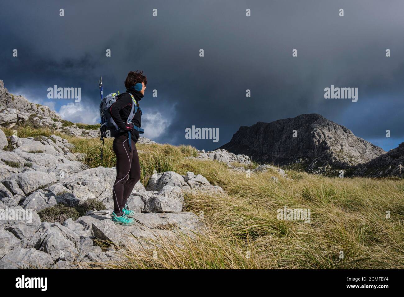 woman on trekk, ascending to Serra Des Teixos, Escorca, Mallorca, Balearic Islands, Spain. Stock Photo