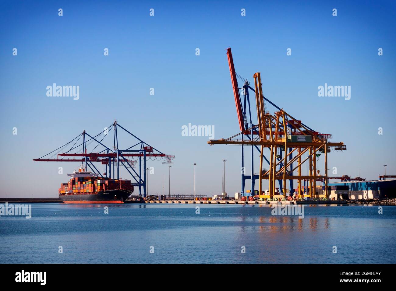 A container ship docked in the Andalucian port of Málaga, an international seaport that's the oldest  operating in Spain. Stock Photo