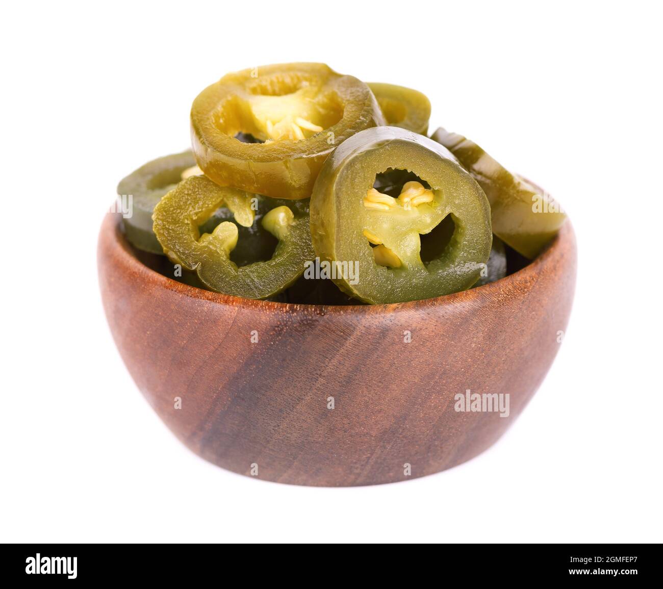 Pickled jalapeno pepper in wooden bowl, isolated on white background. Slices of preserved hot serrano. Stock Photo