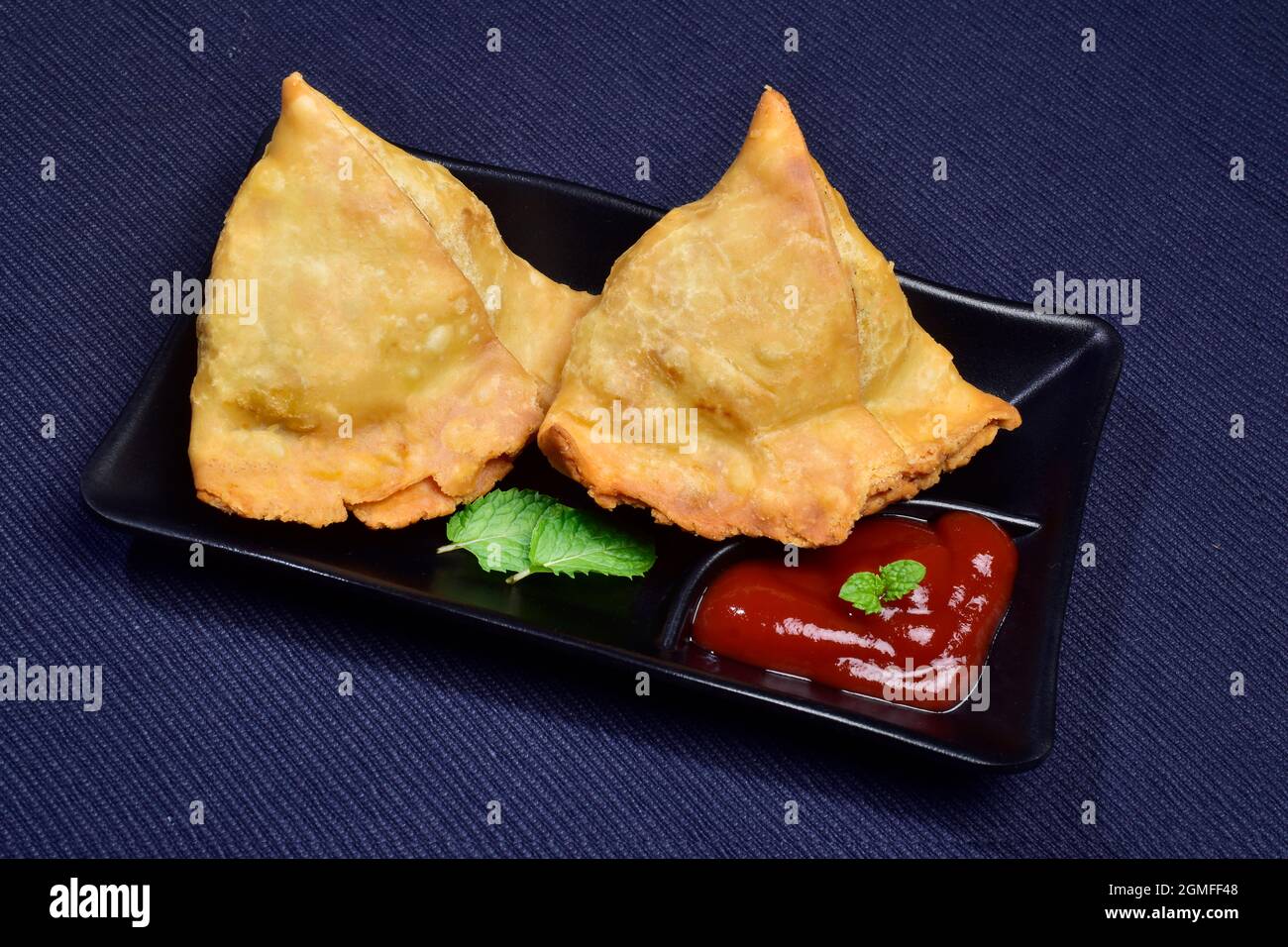 Samosa with Sauce in Plate, Famous Asian Food Stuffed Samosa Stock Photo