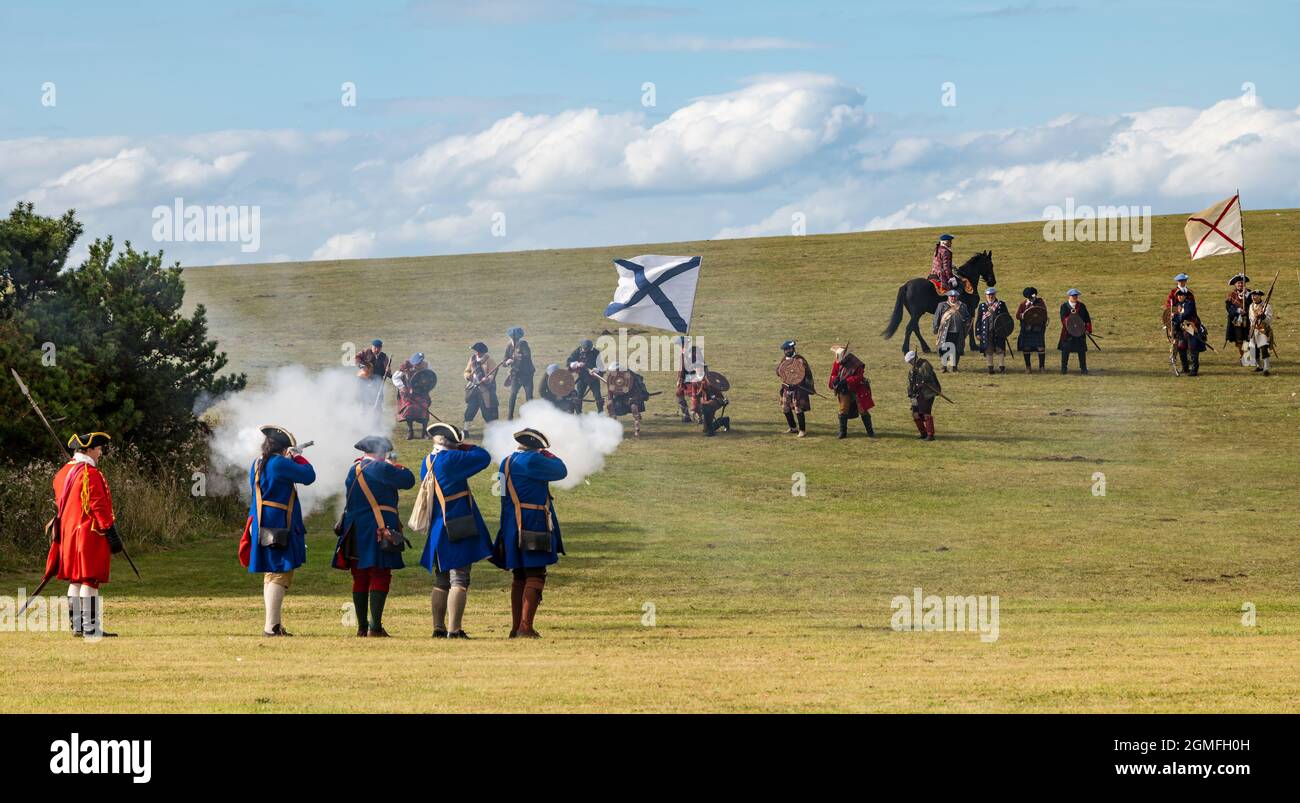 Prestonpans, East Lothian, Scotland, UK, 18 September 2021 Battle of Prestonpans re-enactment: The battle of Prestonpans in 1745 was one of the shortest battles in British history but It was a complete victory for Prince Charles Edward Stuart's Jacobite force against the Hanoverian army led by Sir John Cope. Pictured: The Hanoverian forces (or redcoats) face the Jacobite army Stock Photo