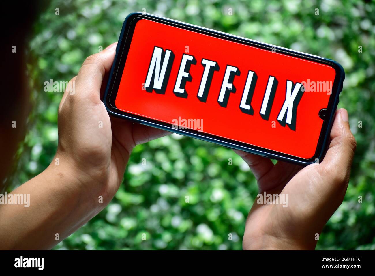 New Delhi, India - September 13, 2019: women use Netflix app on smart phone screen. Netflix is an international leading subscription service for watch Stock Photo