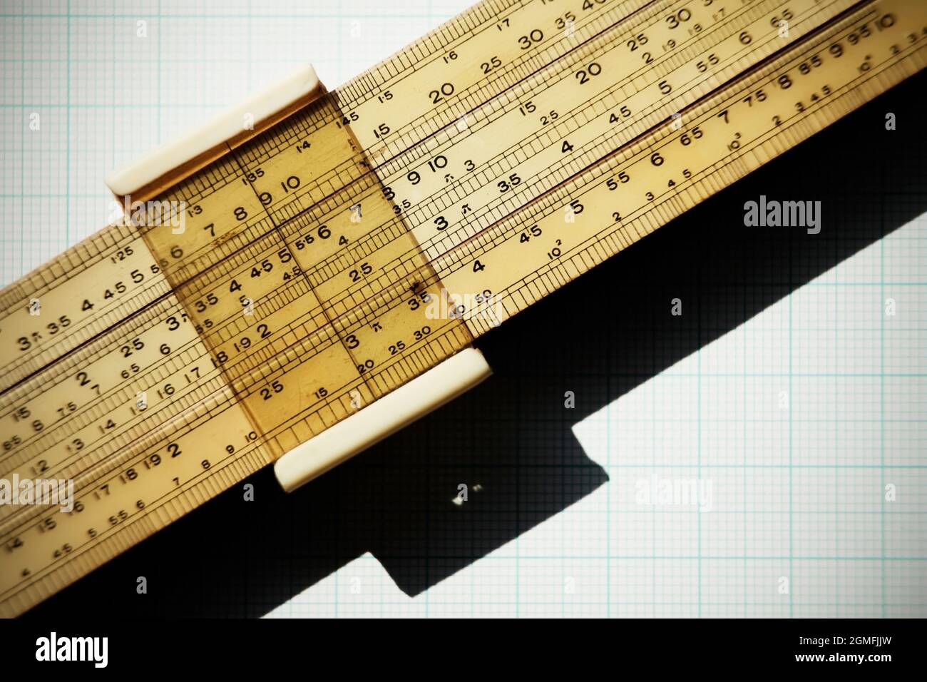 Logarithmic slide rule on piece of graph paper Stock Photo Alamy