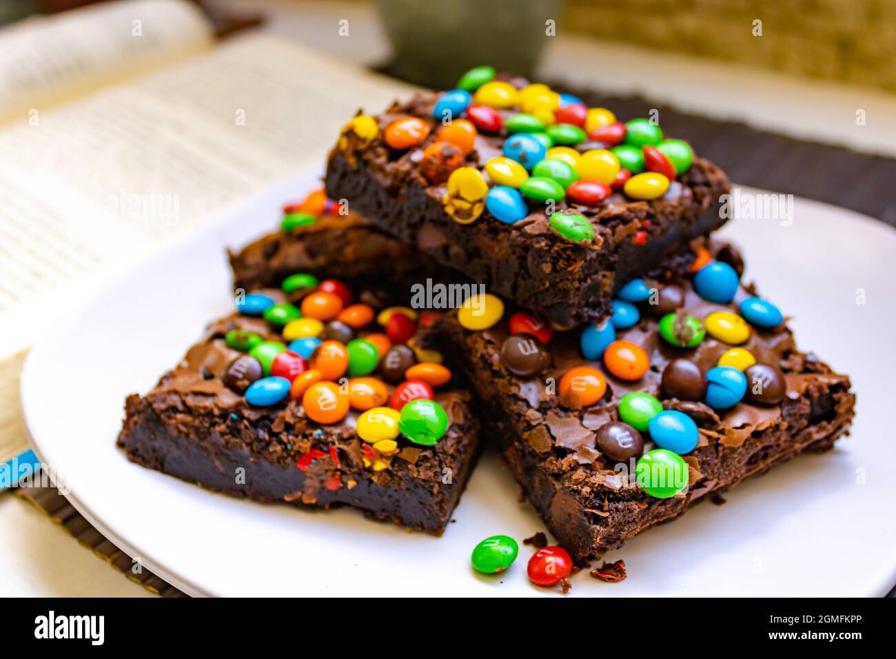 choco M&Ms chocolate brownie - a delicious chocolate brownie topped with  milk chocolate and mini M&M's on white background Stock Photo - Alamy