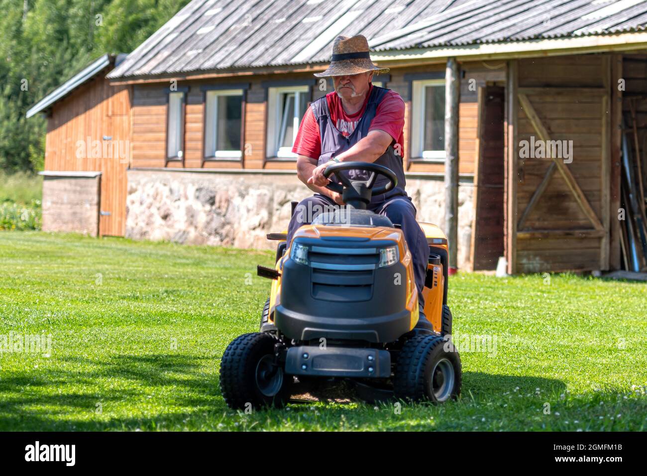 Maintenance man riding tractor hi-res stock photography and images - Alamy