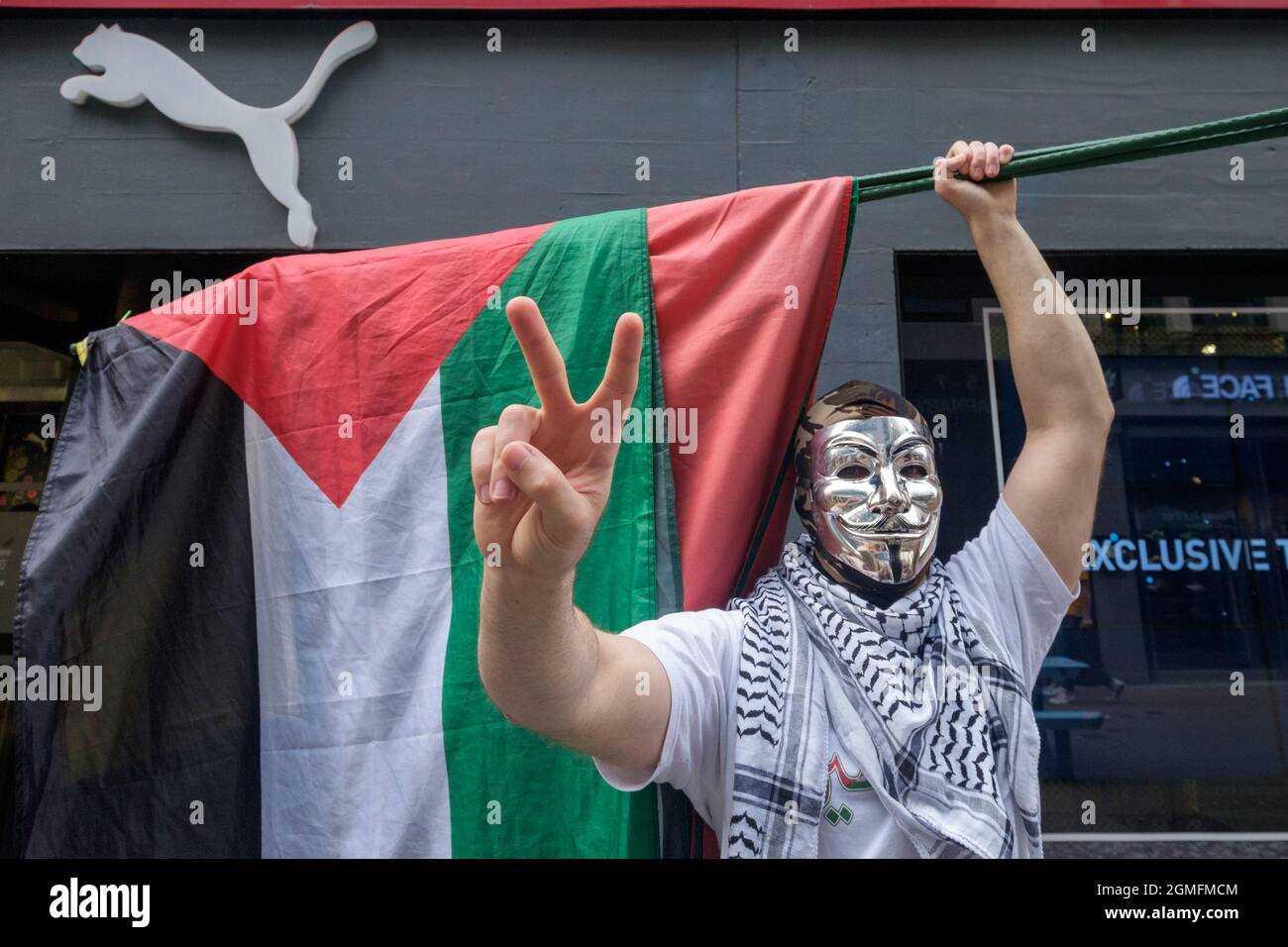 London, UK. 18 Sept 2021. A masked protester poses outside the store.  Campaigners outside the London Puma store in Carnaby Street joined with  groups around the world in a #BoycottPUMA Global Day