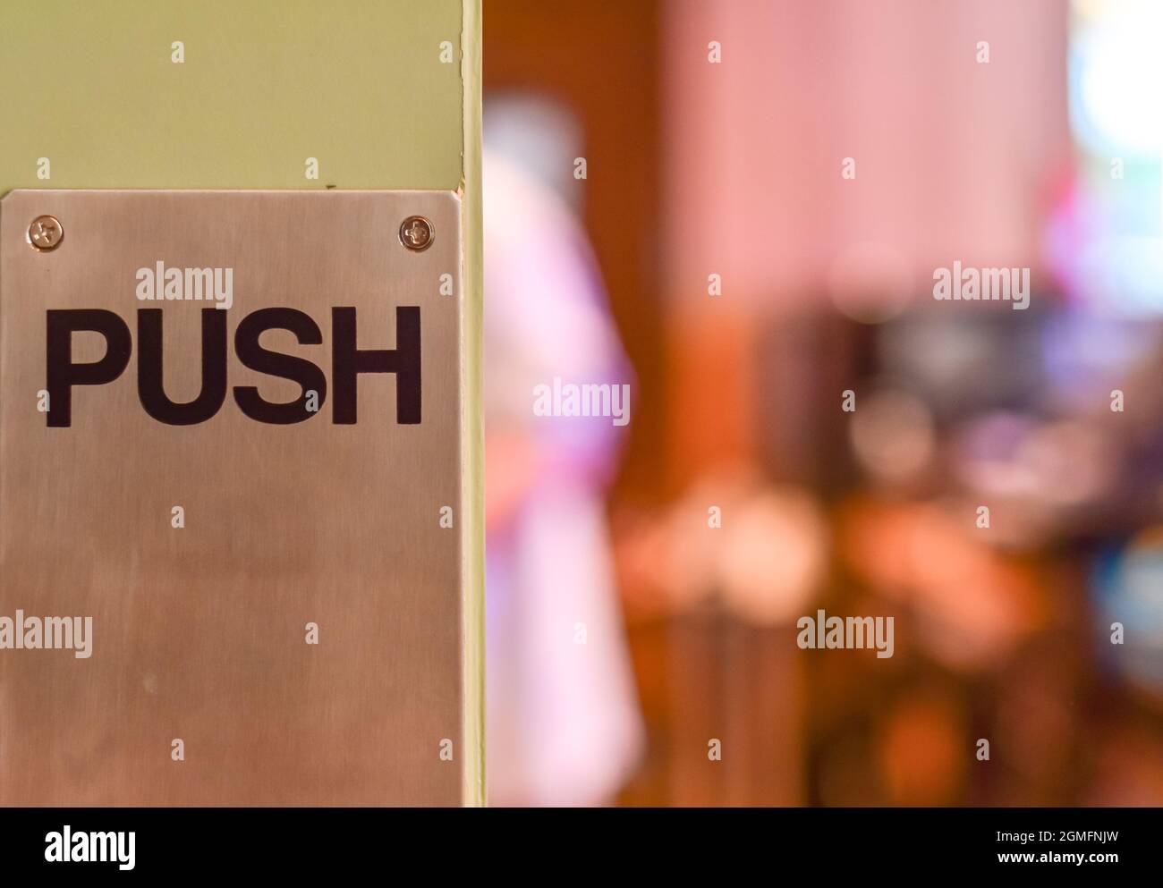 Restaurant wooden door with push sign on the metal plate. Selective ...