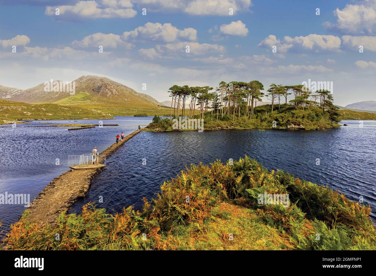 Visitors on causeway to Pines Island in Derryclare Lough, Connemara, County Galway, Republic of Ireland. Eire. Stock Photo