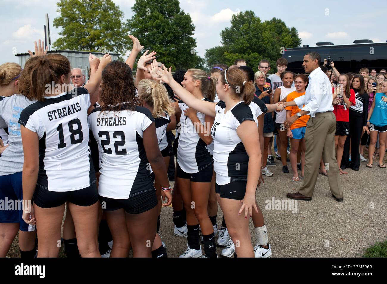 Galesburg Senior High volleyball players join in a cheer after meeting President Barack Obama during an unannounced stop in Galesburg, Ill., Aug. 17, 2011, as part of a three-day bus tour in the Midwest. (Official White House Photo by Pete Souza) This official White House photograph is being made available only for publication by news organizations and/or for personal use printing by the subject(s) of the photograph. The photograph may not be manipulated in any way and may not be used in commercial or political materials, advertisements, emails, products, promotions that in any way suggests ap Stock Photo