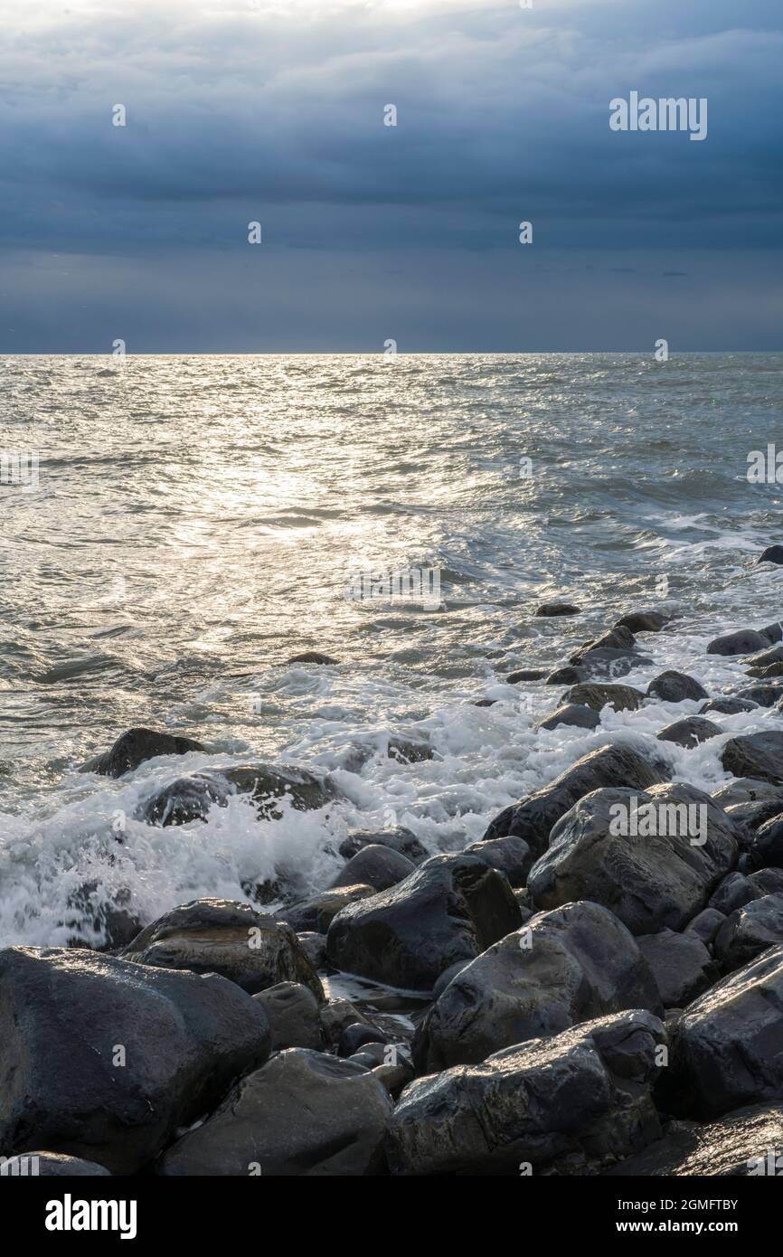 The beach at Llantwit Major with a rough sea and the coast clearly in view south Wales Stock Photo