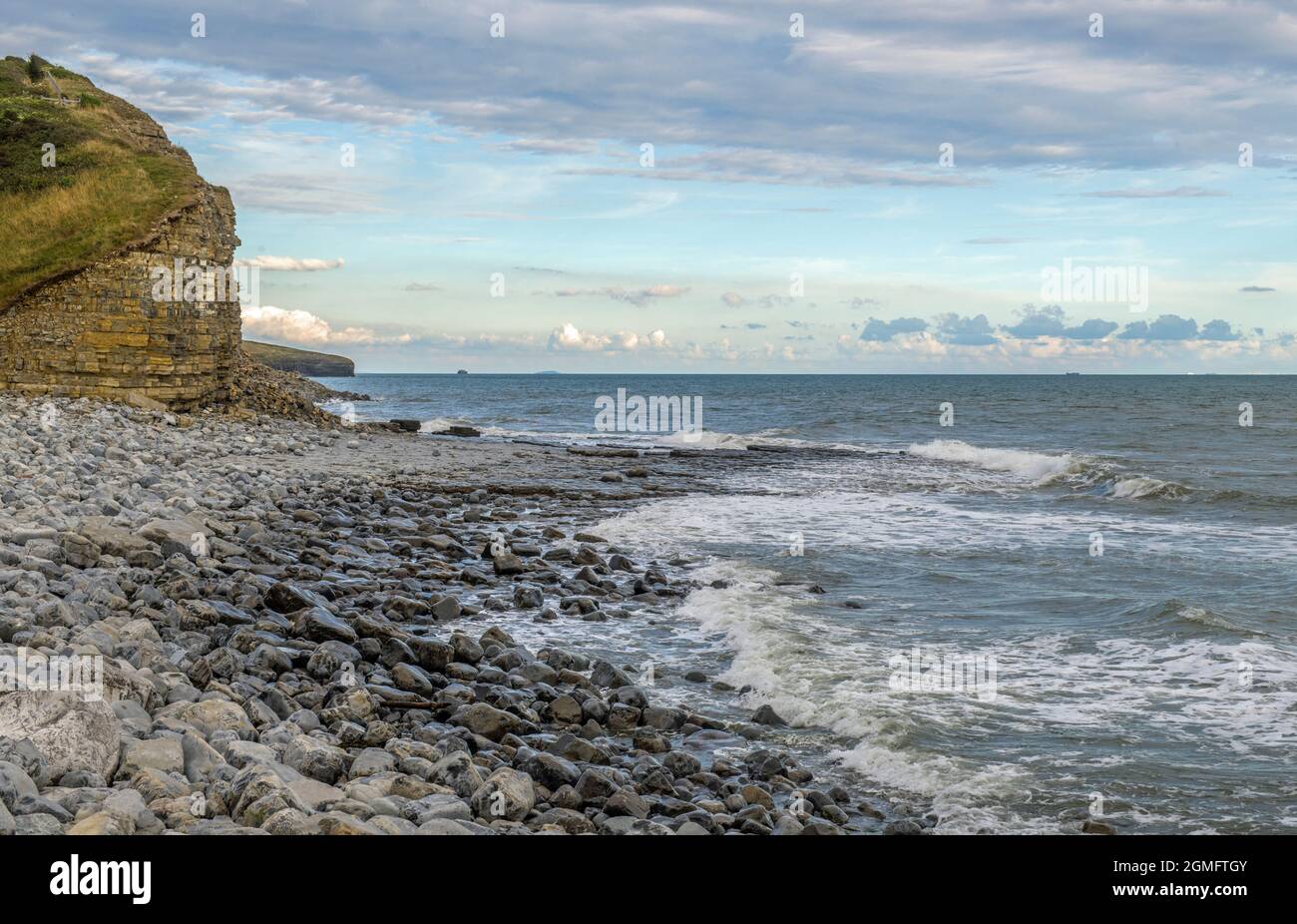The beach at Llantwit Major with a rough sea and the coast clearly in view south Wales Stock Photo