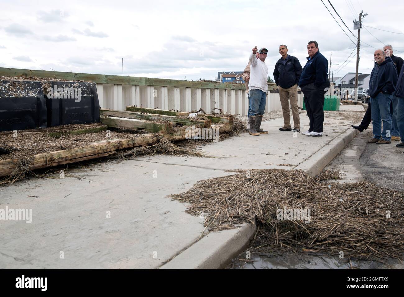 President Barack Obama and New Jersey Gov. Chris Christie talk with citizens who are recovering from Hurricane Sandy, while surveying storm damage in Brigantine, N.J., Oct. 31, 2012. (Official White House Photo by Pete Souza) This official White House photograph is being made available only for publication by news organizations and/or for personal use printing by the subject(s) of the photograph. The photograph may not be manipulated in any way and may not be used in commercial or political materials, advertisements, emails, products, promotions that in any way suggests approval or endorsement Stock Photo