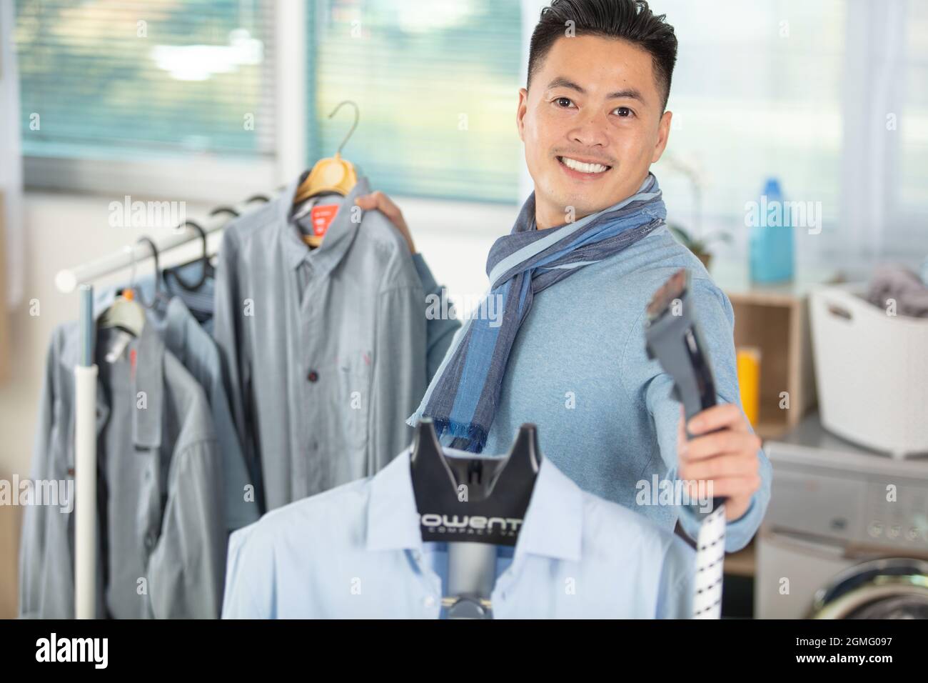 asian man choosing clothes in clothing store Stock Photo - Alamy