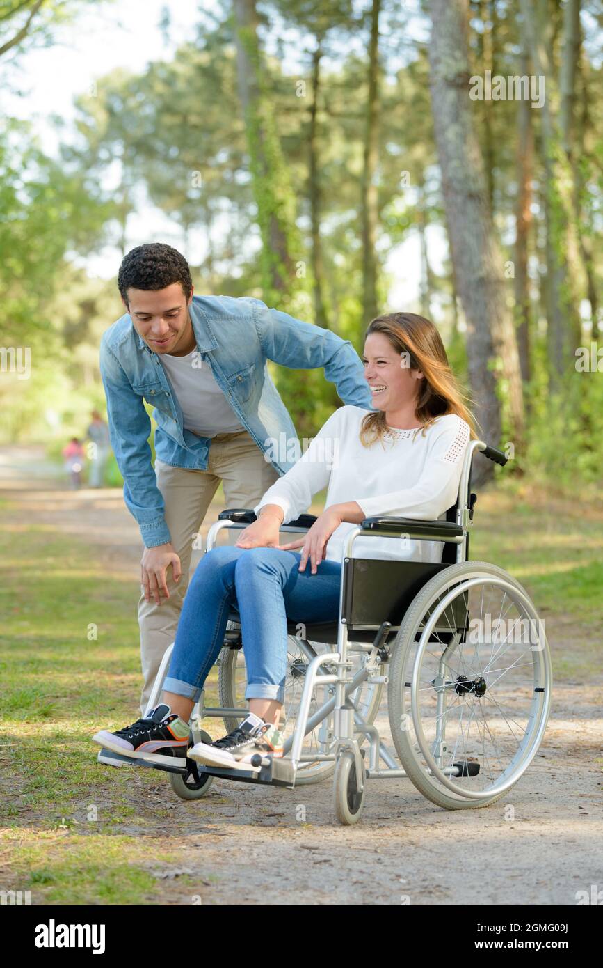 young woman in a wheelchair with boyfriend Stock Photo - Alamy