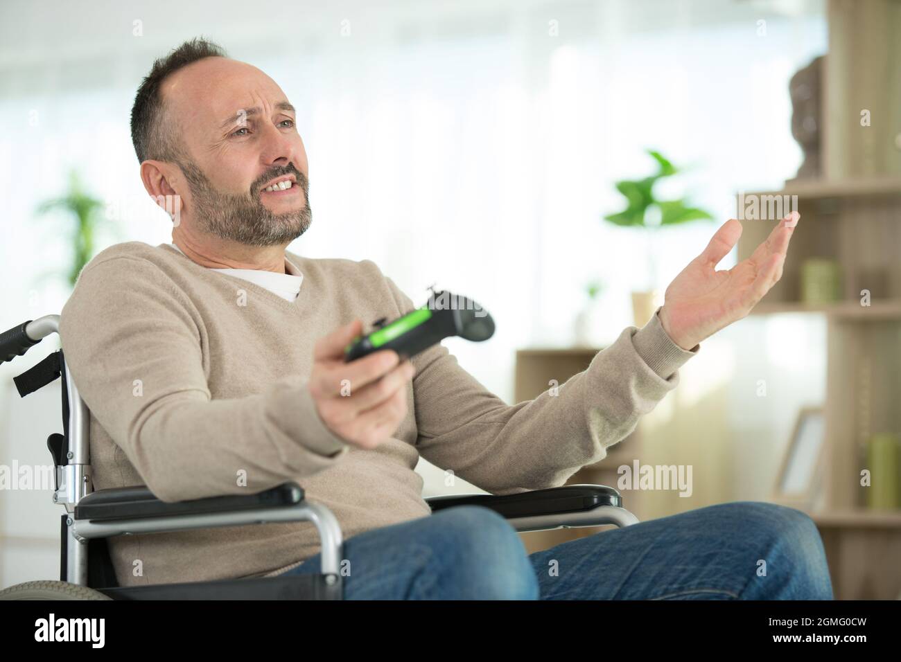 happy disabled man playing computer games during rehabilitation Stock Photo Alamy