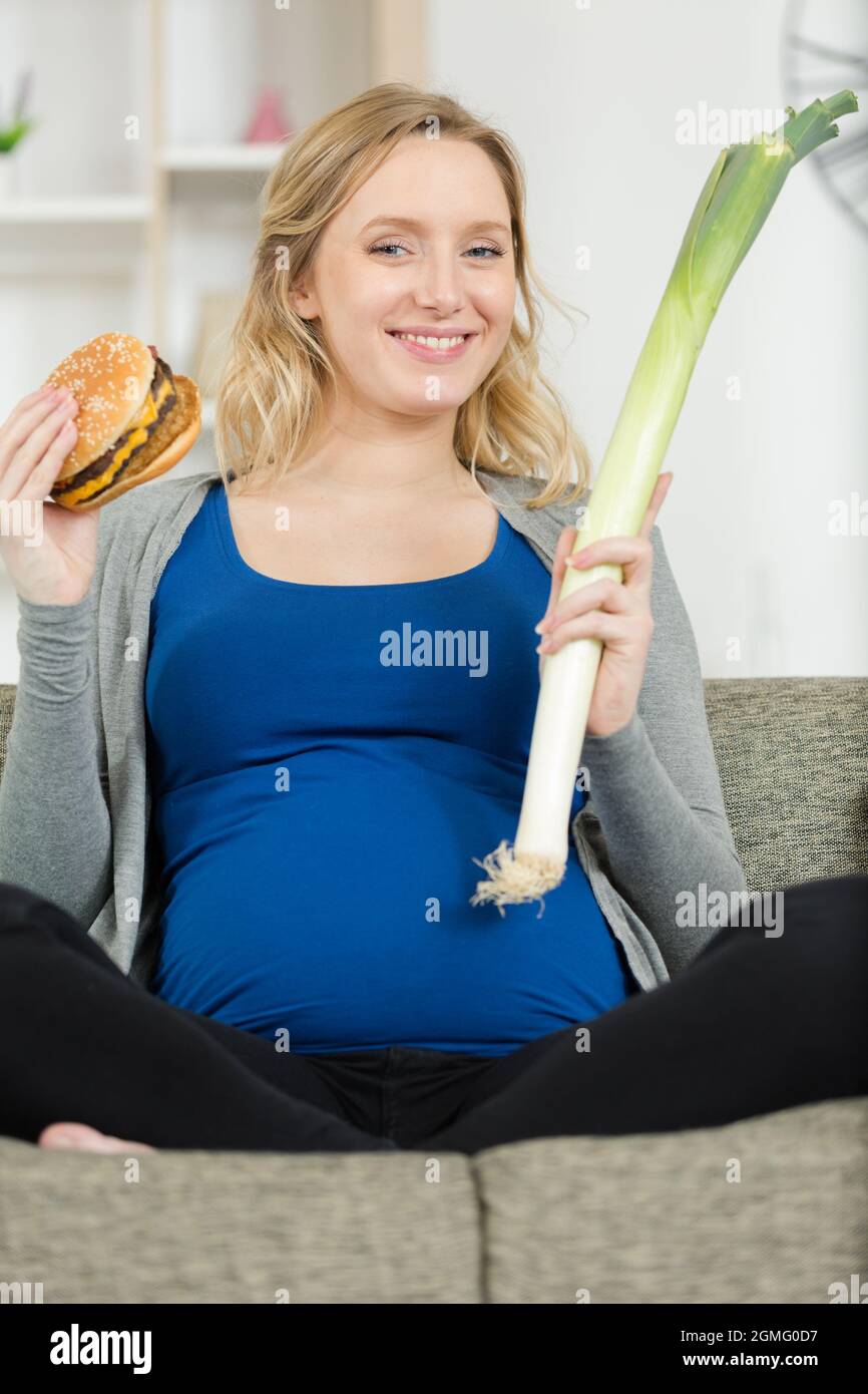 pregnant woman with burger and vegetables Stock Photo Alamy