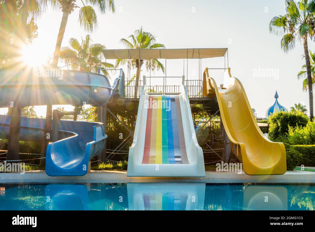 Water park with colorful slides and pools agh the sunrise time Stock