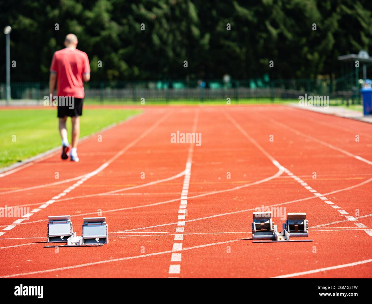 Sportsman walk on the running tracks after training. course. Starrting ...