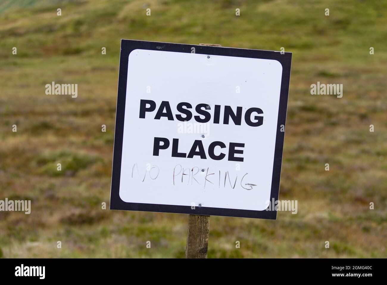 Passing Place sign with 'no parking' hand written underneath - Glen Lyon, Scotland, UK Stock Photo