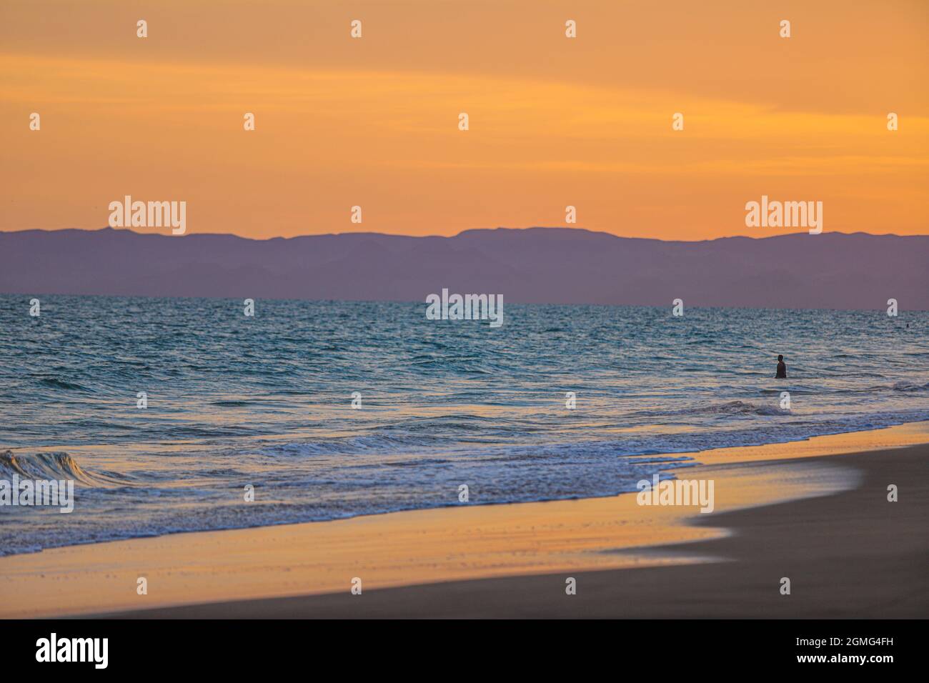 Sea waves on the Bahia de Kino beach at sunset and the island of Tiburon in  Sonora Mexico in the background. landscape, sea and beach in the Gulf of  California, Sea of, image size:1300x956