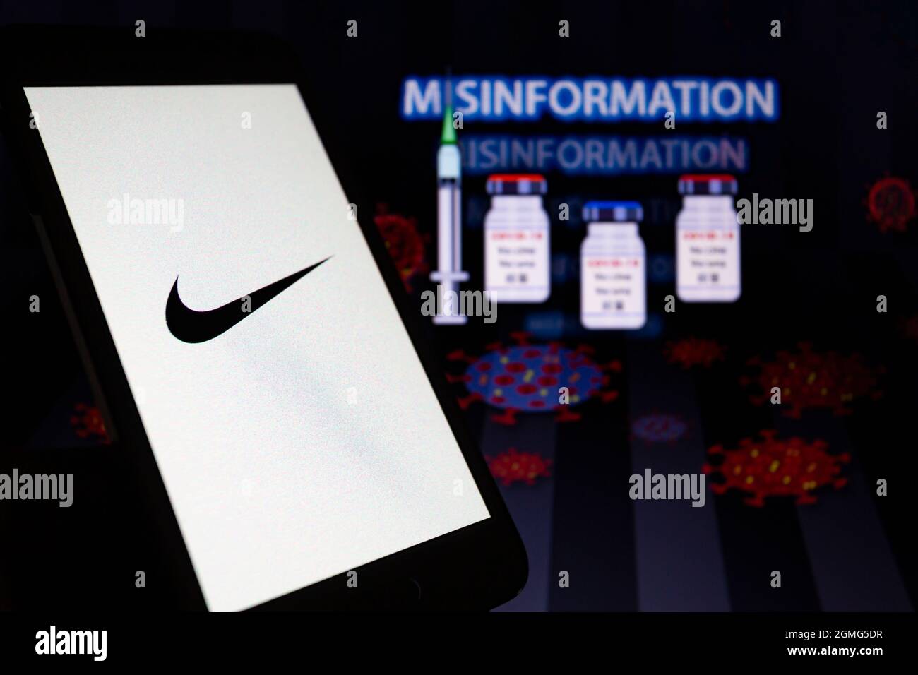 Asuncion, Paraguay. 18th Sep, 2021. Illustration photo - Logo of Nike is  displayed on a smartphone backdropped by the word misinformation, visual  representation of virus, medical syringe and ampoules on screen. (Credit