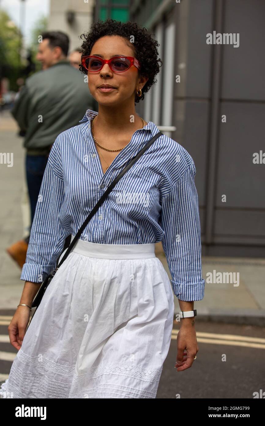 Fashionista in blue stripe shirt and white skirt attends the London Fashion  Week Street Style. (Photo by Pietro Recchia / SOPA Images/Sipa USA Stock  Photo - Alamy